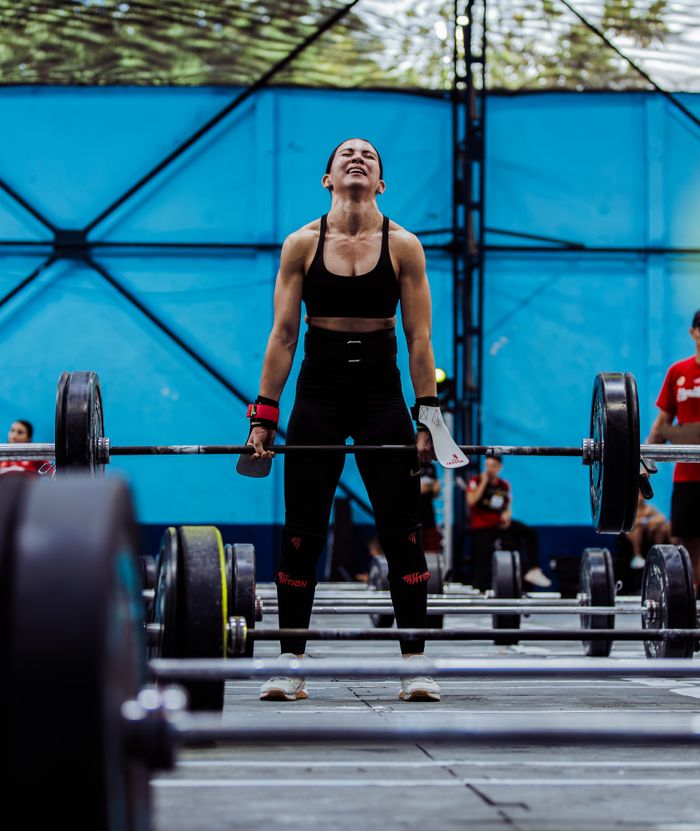 contact-img Strong woman lifting weights in an indoor gym, showcasing strength and determination during a workout